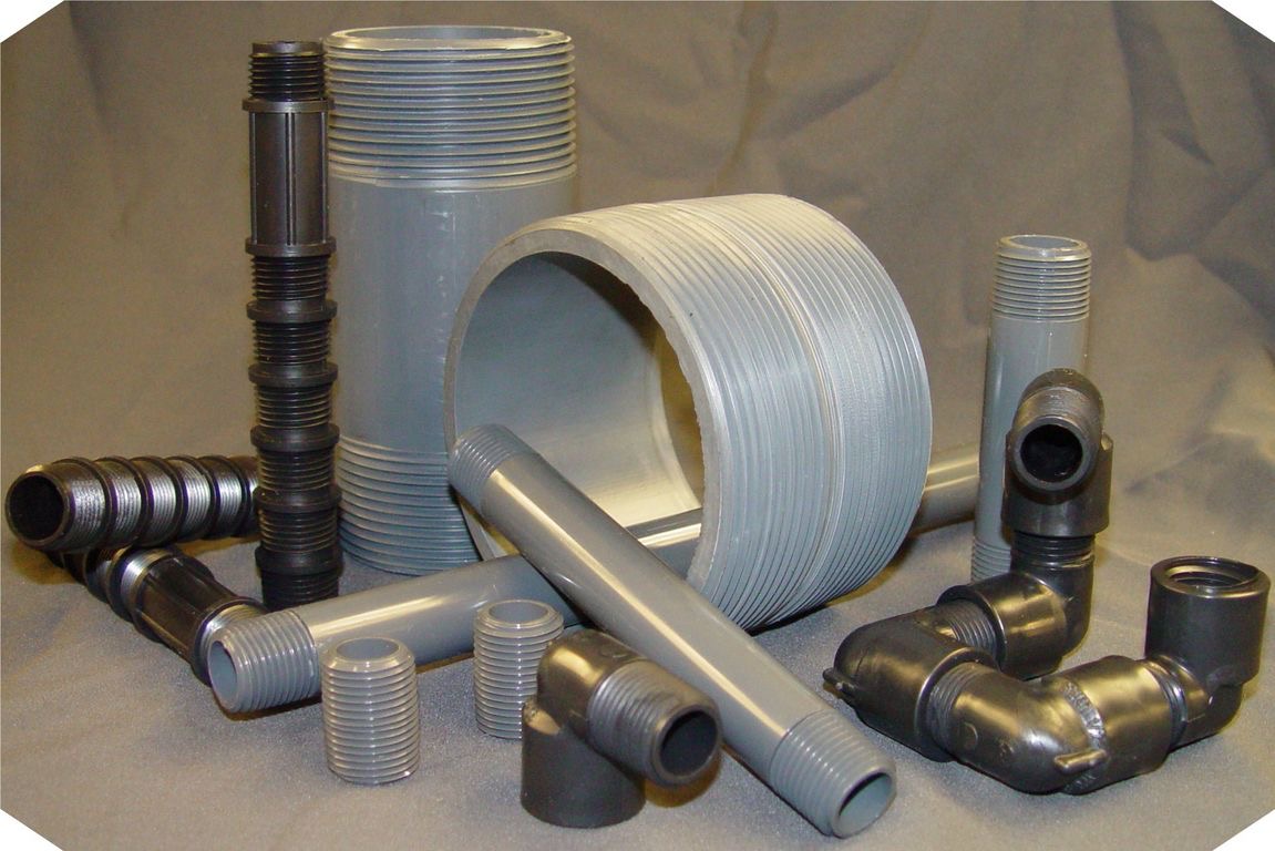 Full range of PVC and CPVC plastic pipe nipples and fittings in gray and black